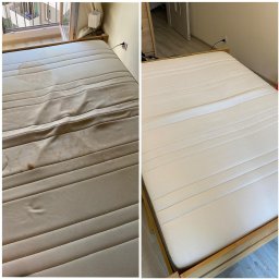 Tania Ewka- mobilne pranie dywanów, tapicerki meblowej i samochodowej, oraz skór - Materac w drewnianej ramie, w ujęciu 'przed i po' praniu. Po lewej stronie widoczne plamy, po prawej czysty, odświeżony materiał. Jasne wnętrze, widok z góry.