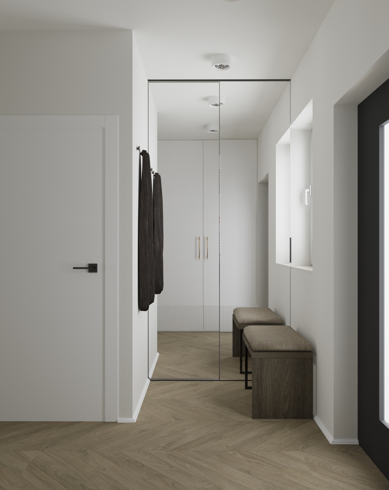 Minimalistyczny przedpokój z lustrem na ścianie, dwiema ławkami z tapicerowanymi siedziskami i parkietem w jodełkę.