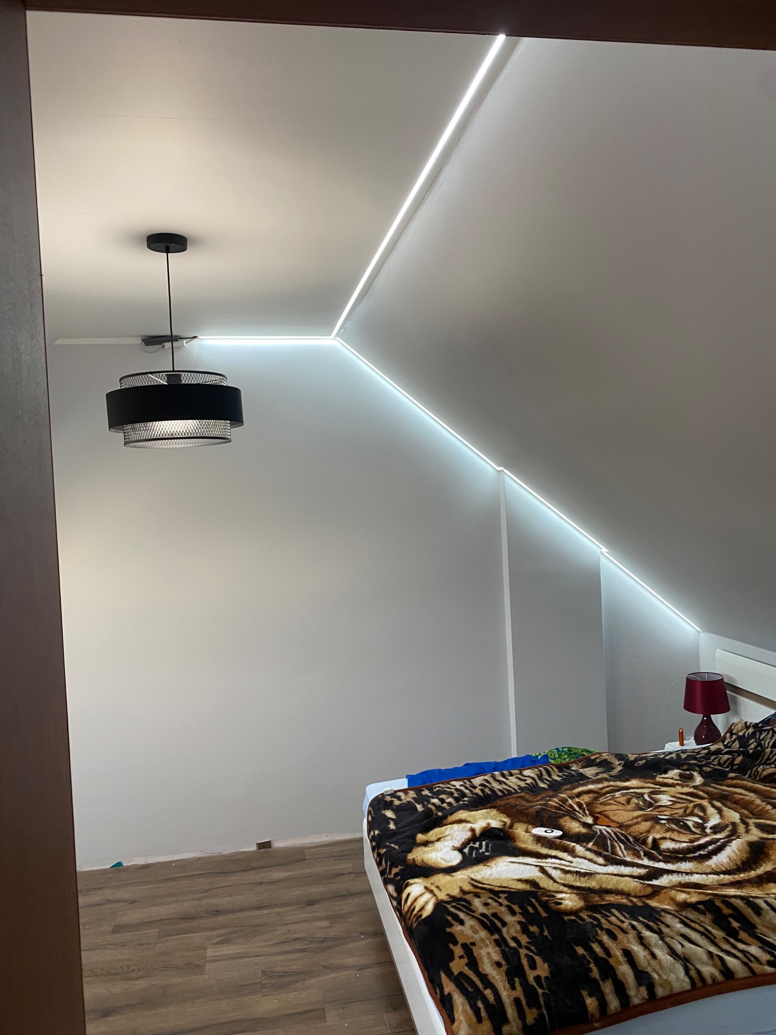 Prace wykonane na zdjęciu; Montaż led, malowanie oraz szpachlowanie ścian, ułożenie paneli, montaż szafek przy łóżku