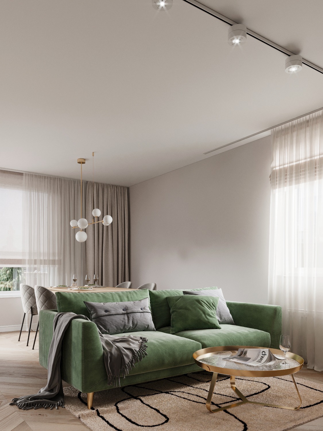 Wnętrze salonu z zieloną sofą, szarym pledem i poduszkami, okrągłym stolikiem kawowym z gazetą, jadalnią w tle i nowoczesnym oświetleniem sufitowym.
