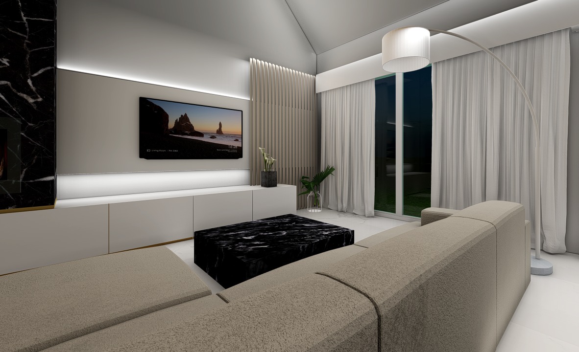 Nowoczesny salon z beżową sofą modułową, czarnym marmurowym stolikiem kawowym i telewizorem z widokiem na plażę w Islandii.