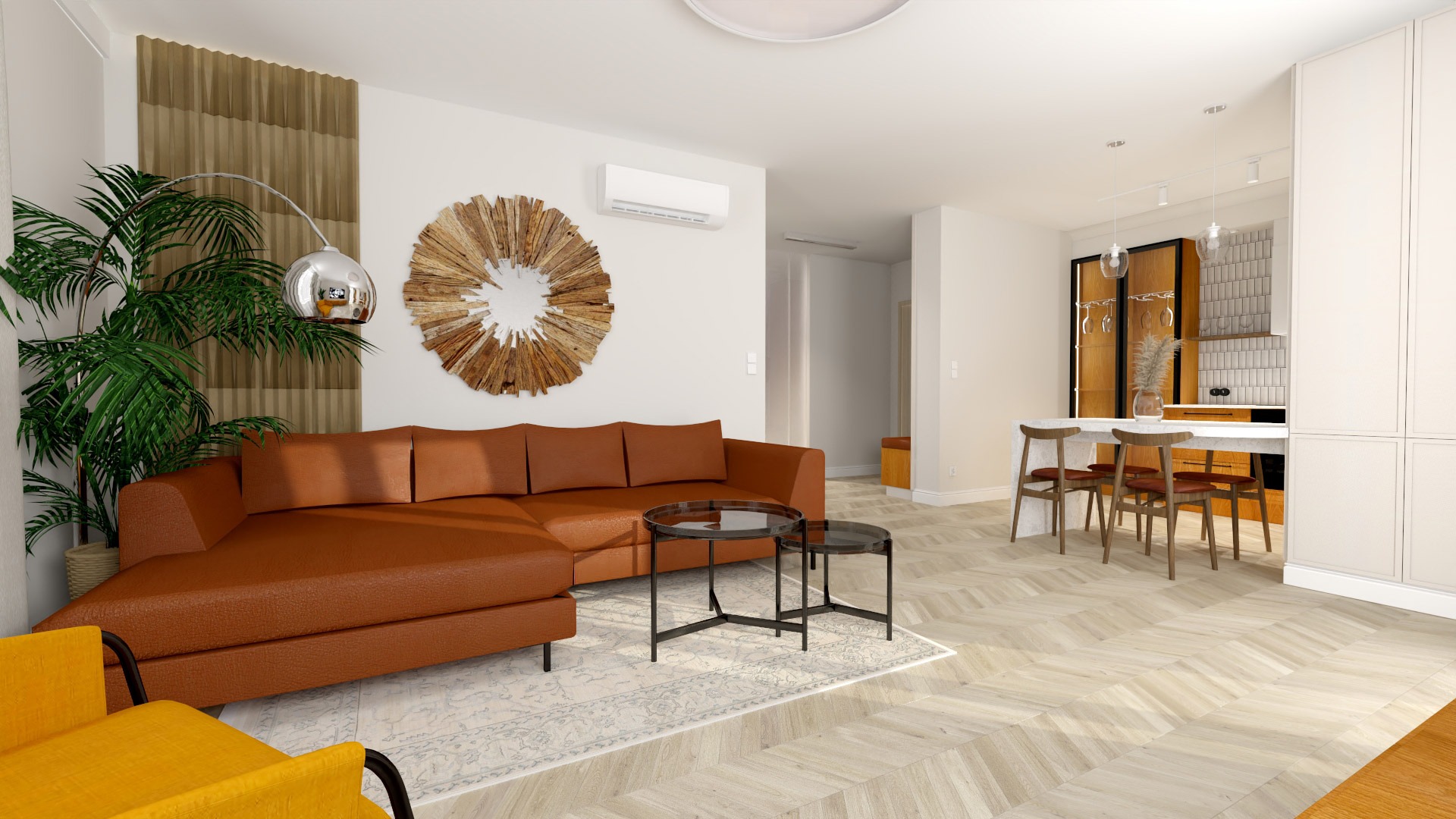 Jasne wnętrze apartamentu z brązową sofą narożną, okrągłym lustrem z drewnianych elementów, parkietem w jodełkę i aneksem kuchennym z barkiem.