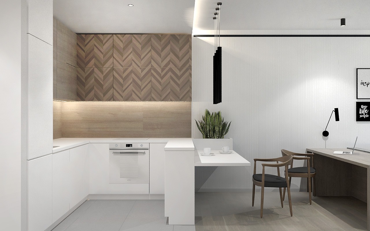 Nowoczesna kuchnia z białymi frontami, drewnianą mozaiką na ścianie, wiszącą lampą i blatem roboczym połączonym z biurkiem, dwie filiżanki na blacie.