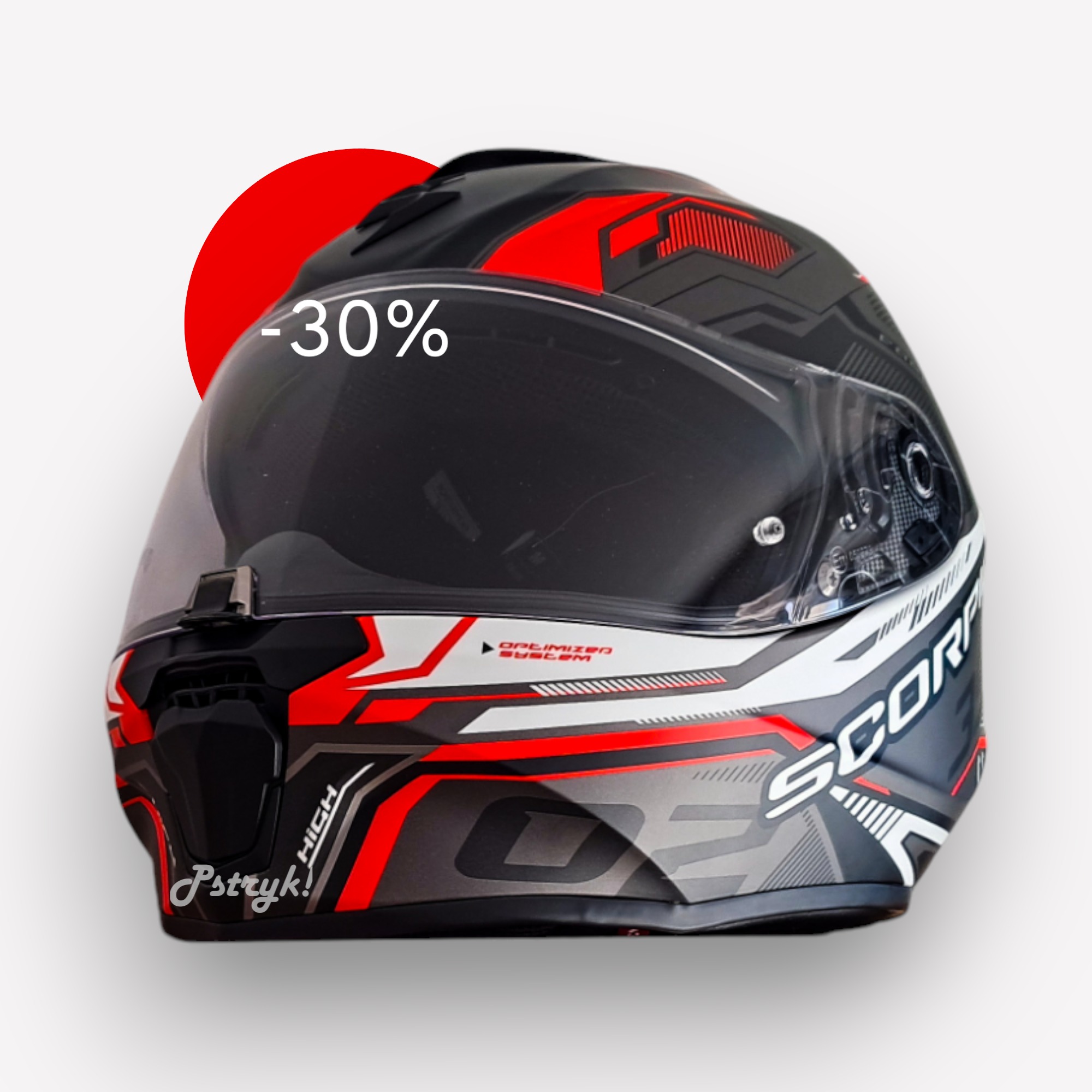 Czarno-szary kask motocyklowy z czerwonymi akcentami i napisem '-30%' na wizjerze, prezentowany na białym tle z czerwonym okręgiem w tle.