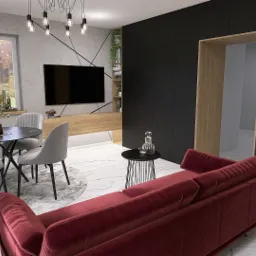 Wizualizacja wnętrza: jadalnia z okrągłym stołem i krzesłami na tle szarej ściany z telewizorem, obok salon z bordową sofą i czarną szafką w zabudowie.