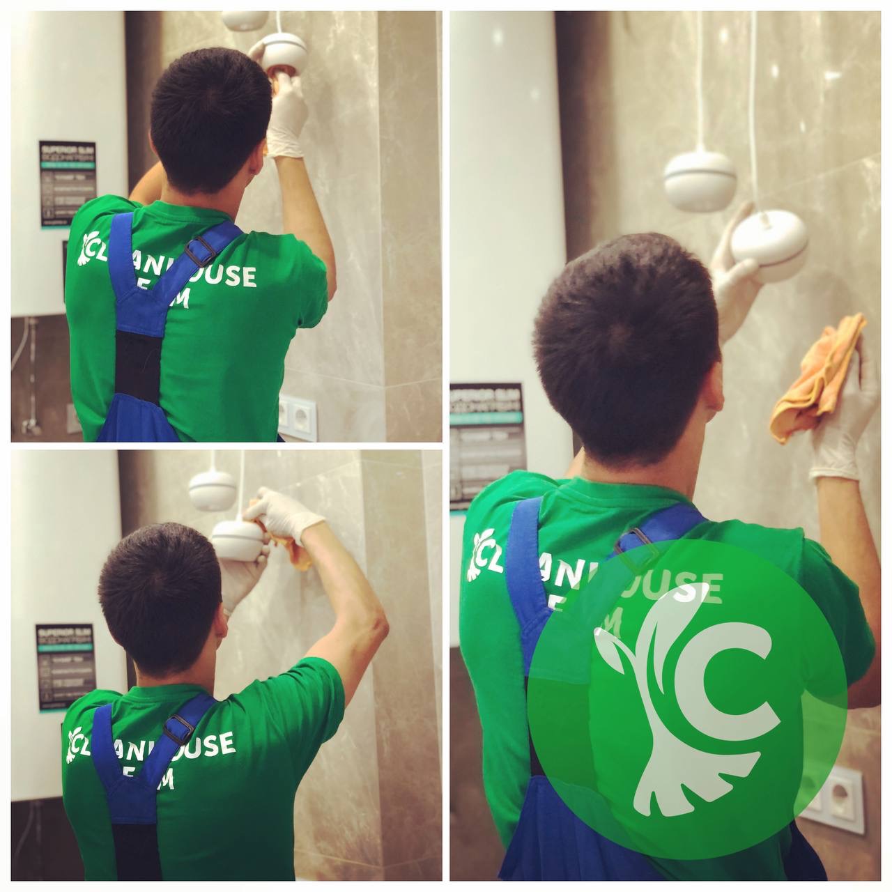 Pracownik w uniformie czyści marmurowe ściany w łazience, używając ściereczki i rękawic ochronnych, widoczne wiszące lampy i logo firmy na plecach.