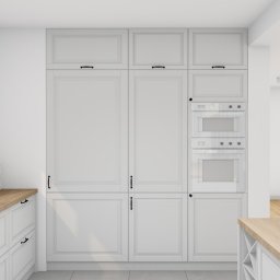 Wnętrz Projektowanie Joanna Zielińska - Wizualizacja kuchni w stylu klasycznym z białymi szafkami, drewnianym blatem i sprzętami AGD w zabudowie, widok na otwartą przestrzeń salonu.