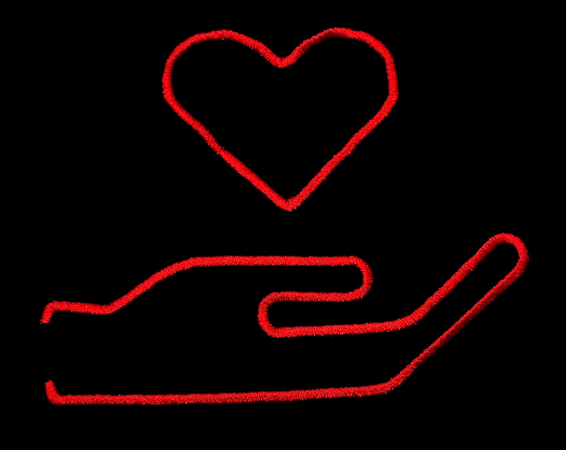 Czerwony kontur serca unoszący się nad konturem dłoni na czarnym tle, wykonany z drobnych włókien, przypominający haft lub szew.