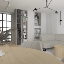 Jasne wnętrze mieszkania z narożną sofą, okrągłym stolikiem kawowym i regałami. Na pierwszym planie stół z filiżanką kawy i dekoracyjną rośliną. Minimalistyczny design.