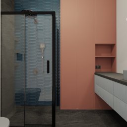 COLIBRIART PRACOWNIA WNĘTRZ EWA ŚWIDERSKA-BASIAK - Wizualizacja łazienki z kabiną prysznicową w czarnej ramie, umywalką na szafce z ryflowanym frontem i lustrem z podświetleniem. Akcent kolorystyczny: koralowa ściana.