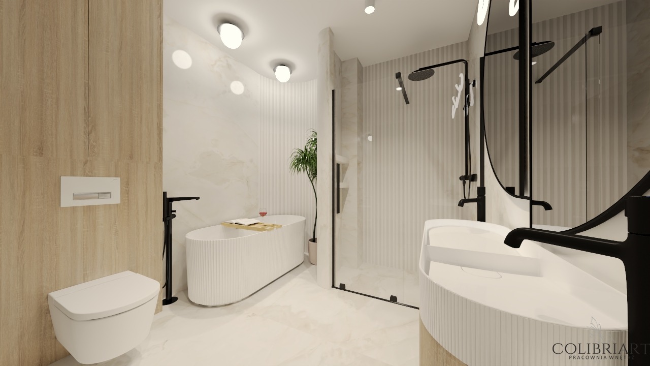 Nowoczesna łazienka z wolnostojącą wanną, minimalistyczną umywalką i czarną armaturą. Jasne płytki imitujące marmur i subtelne oświetlenie tworzą elegancki klimat.