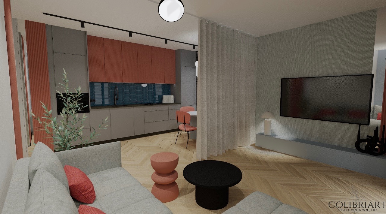 Wnętrze mieszkania z otwartą kuchnią, salonem i jadalnią. Nowoczesny design z elementami koralowymi i szarymi. Parkiet w jodełkę. Widoczny fragment sofy i stolika.