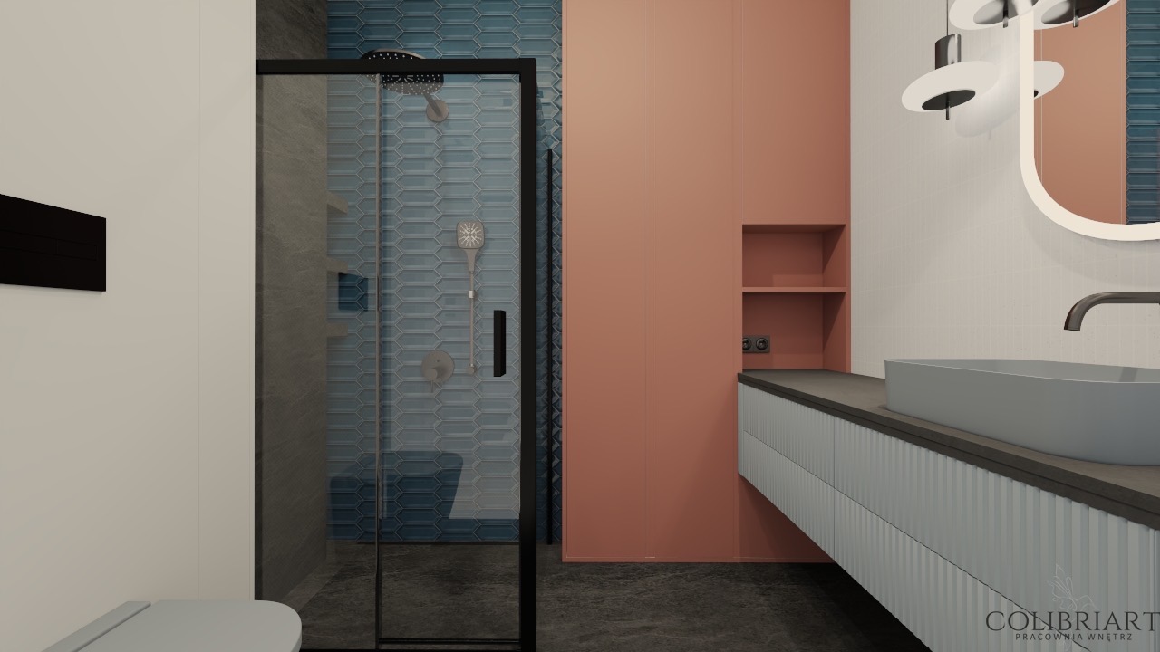 Wizualizacja łazienki z kabiną prysznicową w czarnej ramie, umywalką na szafce z ryflowanym frontem i lustrem z podświetleniem. Akcent kolorystyczny: koralowa ściana.