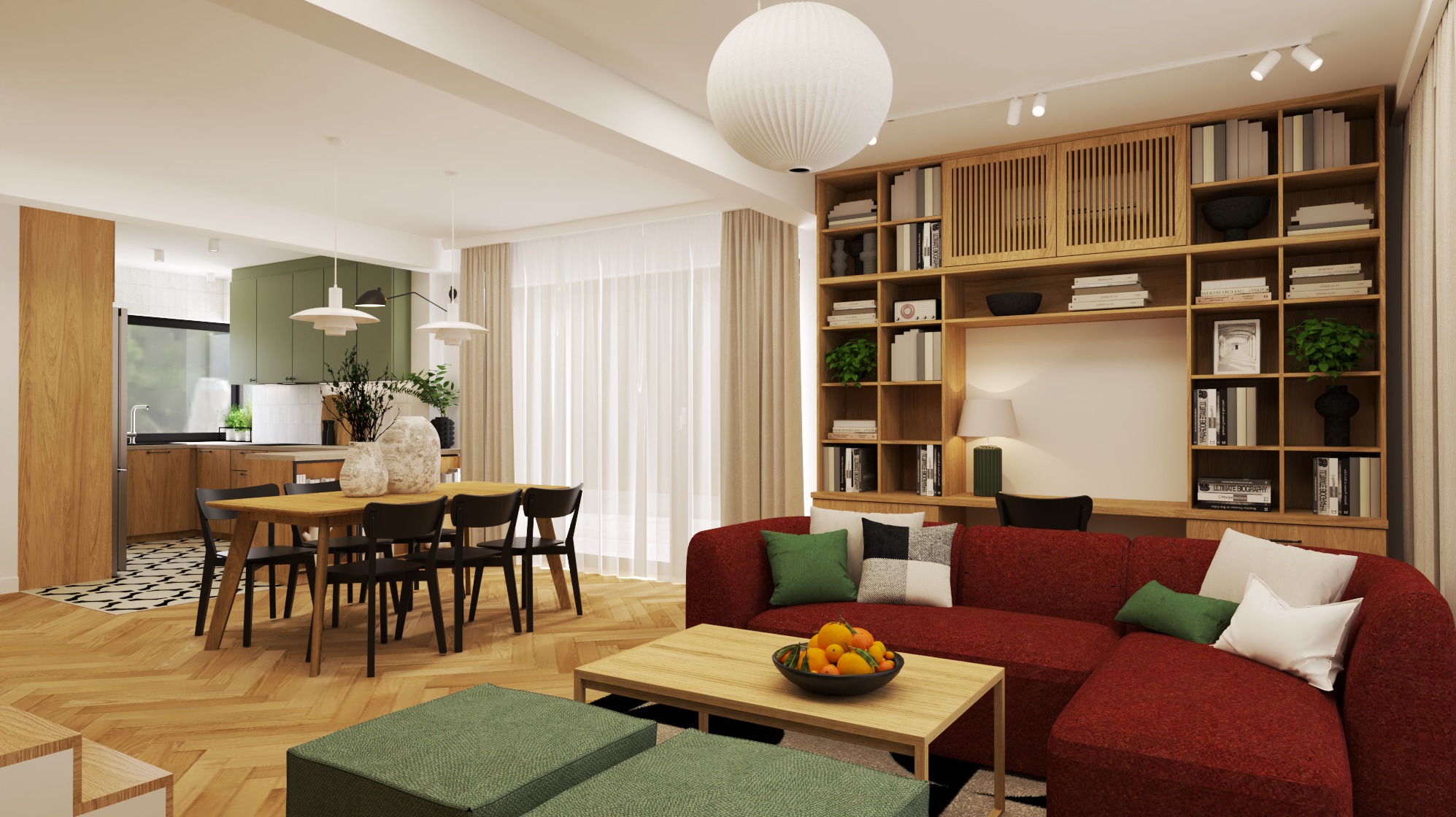 Jasne wnętrze z otwartą kuchnią, drewnianym stołem i czerwonym narożnikiem. Na stole owoce w misie. Na ścianie regał z książkami i dekoracjami. Parkiet ułożony w jodełkę.