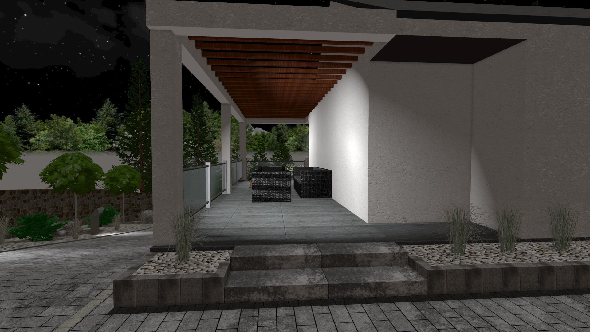 Oświetlony taras z meblami ogrodowymi z widokiem na ogród nocą, wykończony kostką brukową i obrzeżami.