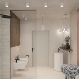 Nowoczesna łazienka z kabiną prysznicową typu walk-in, białą ceramiką, grzejnikiem w kolorze miedzi oraz designerskim stołkiem w czarno-białe kropki.