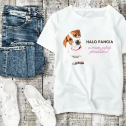 Biała koszulka z nadrukiem psa rasy Jack Russell Terrier i napisem 'Halo Pancia a może jakaś przekąska?', leżąca obok dżinsów i białych trampek na drewnianym tle.