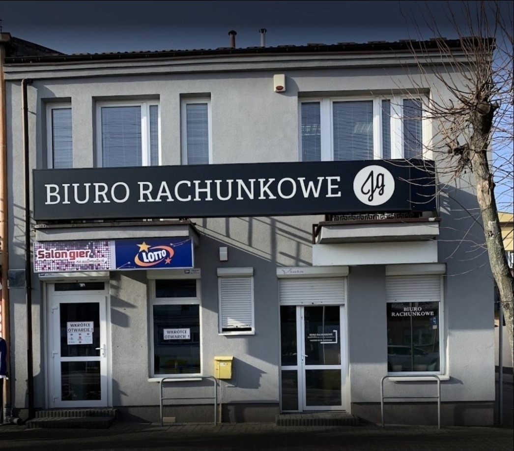 Fasada budynku z szyldem 'Biuro Rachunkowe' nad wejściami, obok punkt Lotto i salon gier.