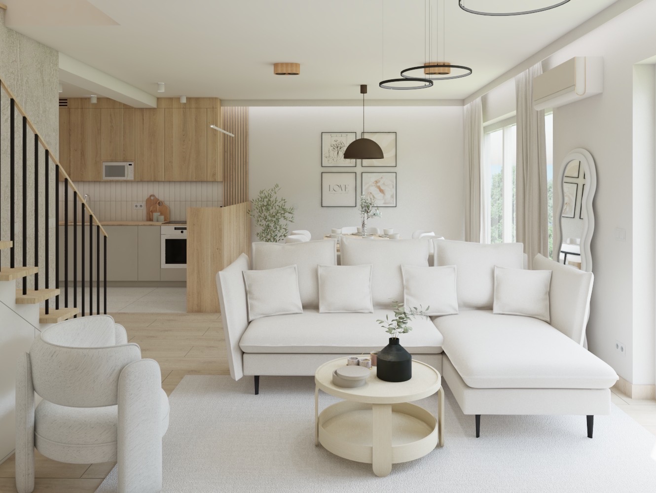 Jasne, przestronne wnętrze mieszkania z otwartą kuchnią, białym narożnikiem, okrągłym stolikiem kawowym i schodami z czarnymi poręczami.