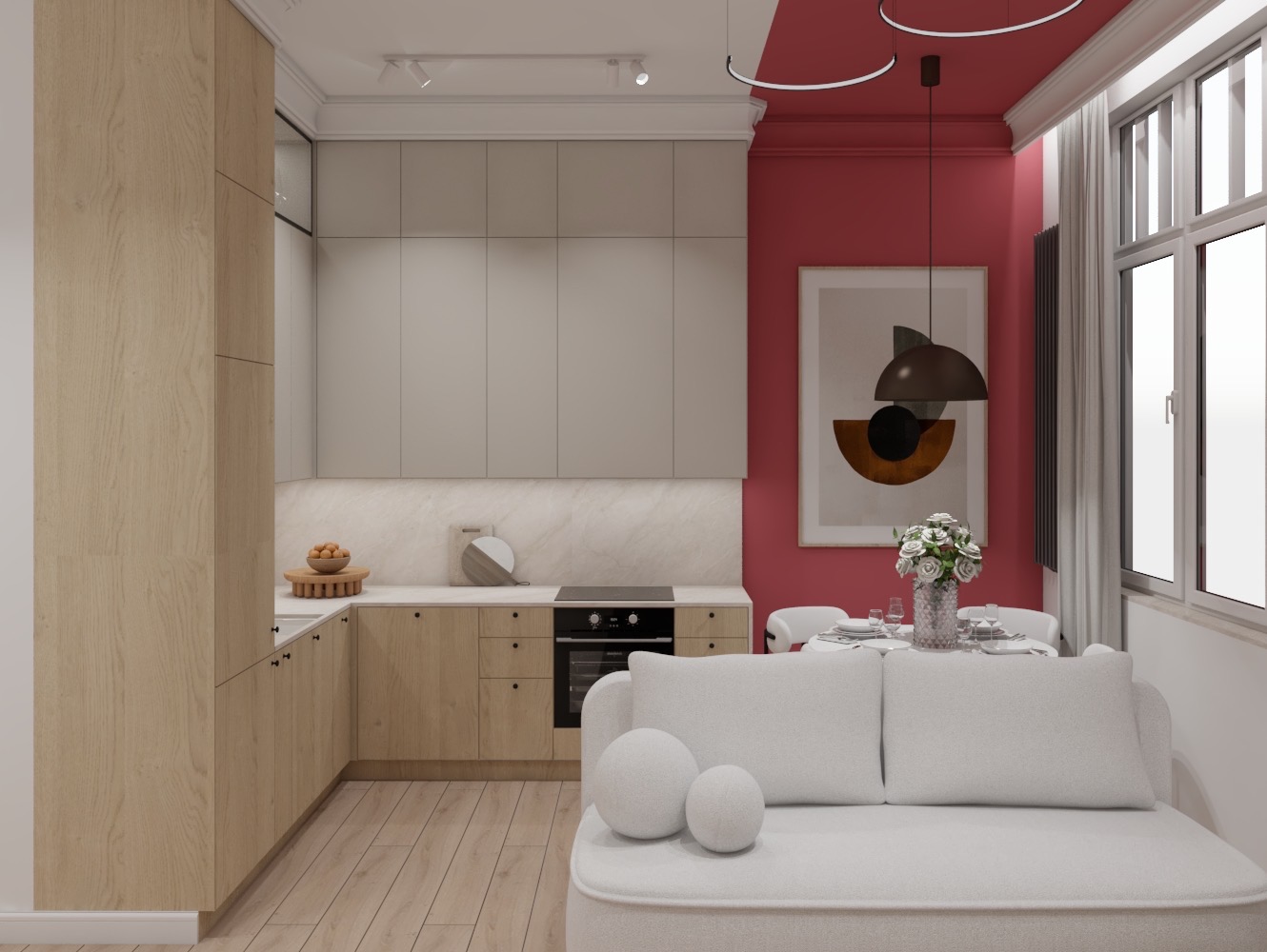 Jasna kuchnia z drewnianymi frontami, szarą zabudową górną i czerwonym akcentem na ścianie oraz suficie, widoczna z perspektywy salonu z białą sofą.