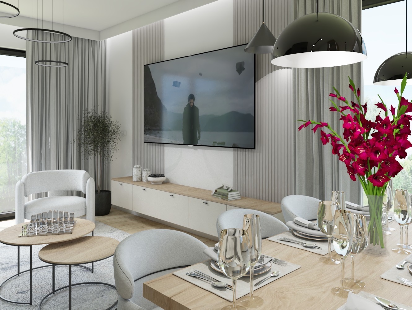Nowoczesny salon z telewizorem, białymi meblami i kwiatami na stole. Widoczne krzesła o opływowych kształtach, okrągłe stoliki kawowe i minimalistyczne lampy wiszące.