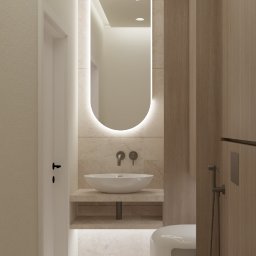 Asilé Privé Design - Minimalistyczna łazienka w odcieniach beżu z podświetlanym lustrem, wiszącą umywalką i toaletą podwieszaną z bidetką.