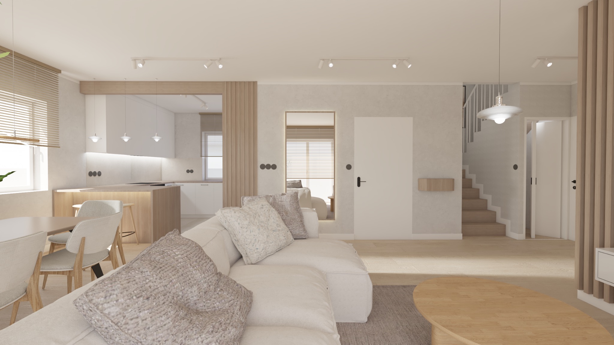 Jasne, przestronne wnętrze z otwartą kuchnią, jadalnią i salonem. Biała sofa z dekoracyjnymi poduszkami na pierwszym planie, dalej stół z krzesłami, wyspa kuchenna i białe szafki. W tle schody...