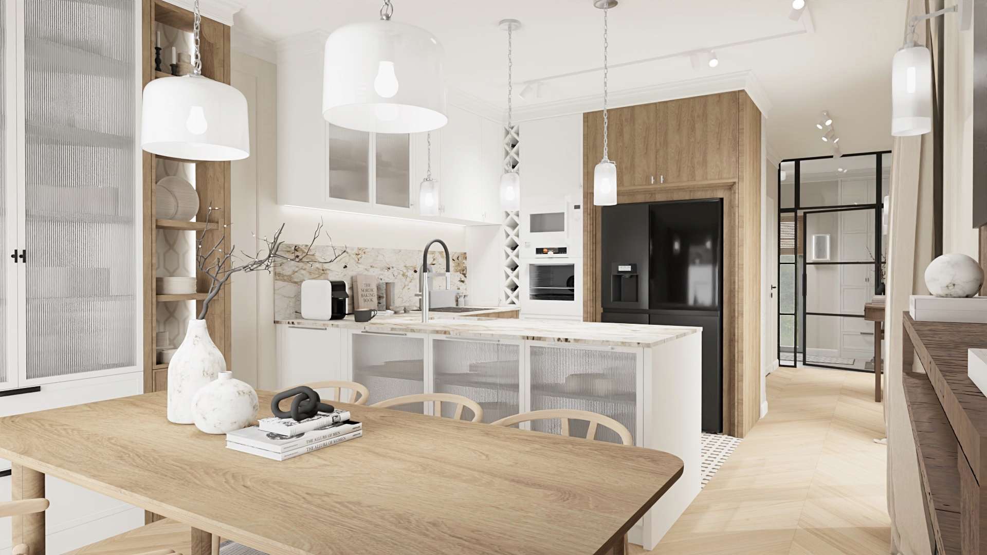 Jasna kuchnia z wyspą i drewnianym stołem w Warszawie. Na blacie dekoracyjne wazony i książki, w tle zabudowa kuchenna z marmurowym blatem i czarną lodówką.