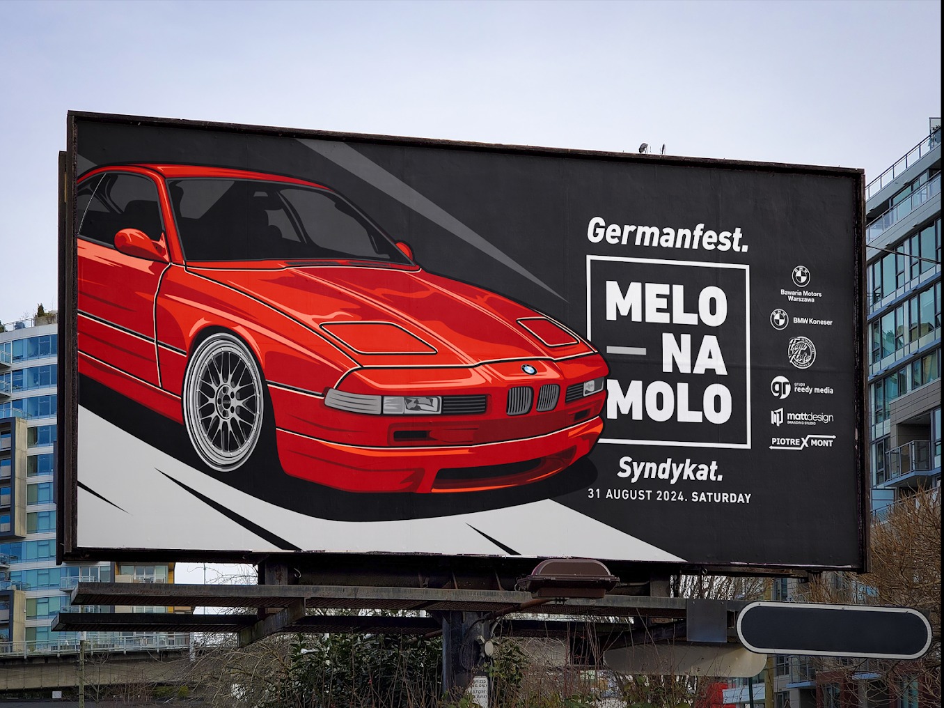 Billboard reklamujący wydarzenie Germanfest z ilustracją czerwonego BMW E31, hasłem 'MELO NA MOLO' i logotypami sponsorów, umieszczony w miejskiej przestrzeni.