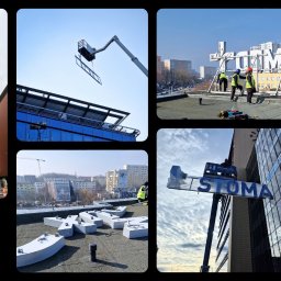 ReklaMaster MONIKA SZCZĘSNA - Montaż wielkoformatowych liter na budynku biurowym z użyciem podnośnika koszowego. Prace na dachu i elewacji, widok na panoramę miasta w tle.
