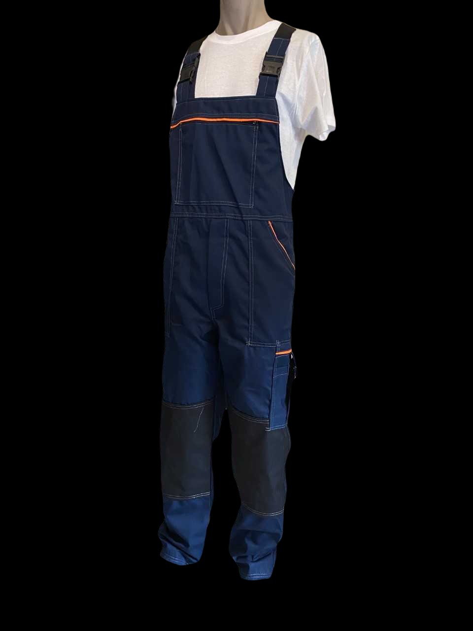 Granatowe ogrodniczki robocze z pomarańczowymi akcentami i wzmocnieniami na kolanach, prezentowane na manekinie z białą koszulką.