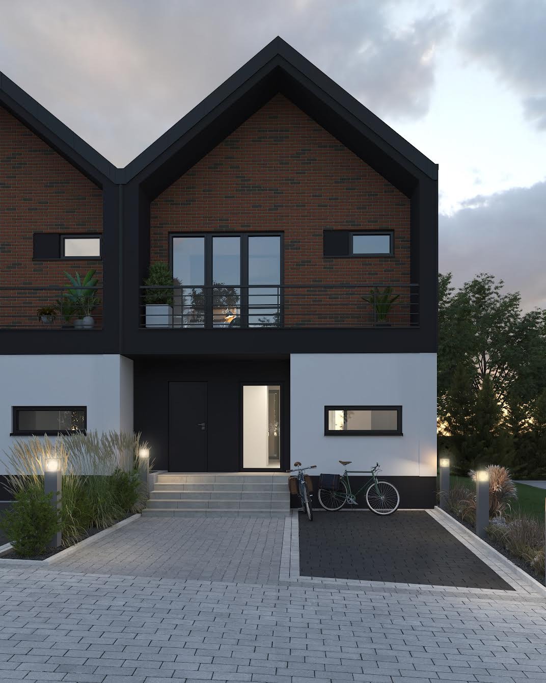 Nowoczesny dom dwurodzinny z ceglaną elewacją, czarnymi ramami okiennymi i balkonem, oświetlony lampami zewnętrznymi, z dwoma rowerami zaparkowanymi przed wejściem, na tle pochmurnego nieba.