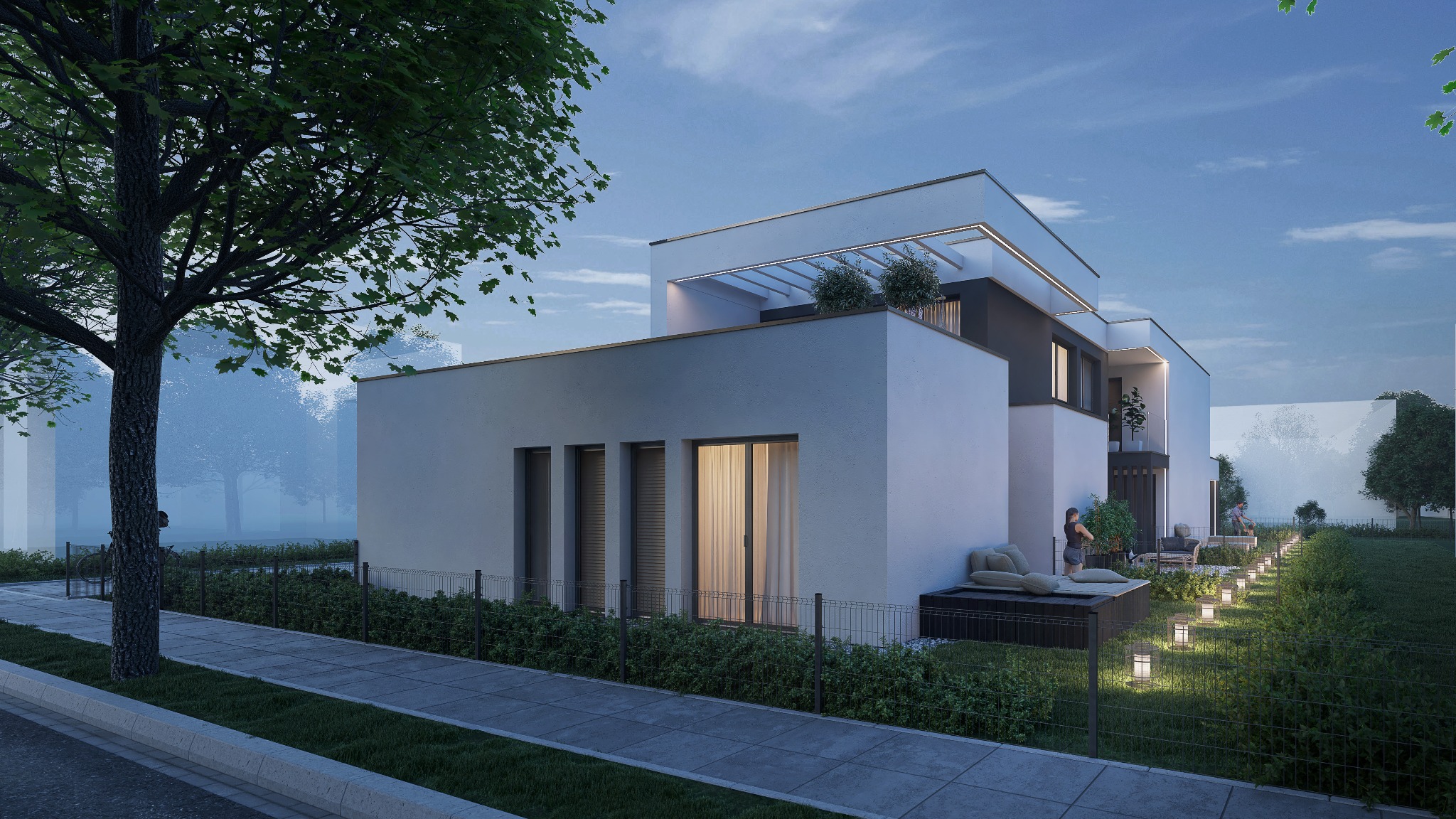 Nowoczesny, dwukondygnacyjny dom z płaskim dachem i oświetleniem zewnętrznym, widoczny z perspektywy ulicy z chodnikiem i ogrodzeniem z siatki.