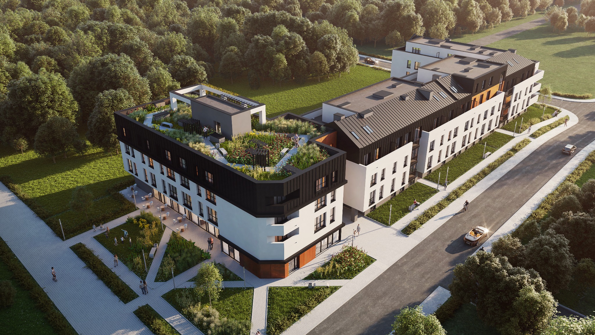 Wizualizacja z lotu ptaka nowoczesnego budynku wielorodzinnego z zielonym dachem i zagospodarowanym terenem wokół, przedstawiająca ludzi spacerujących po chodnikach i zieleni.