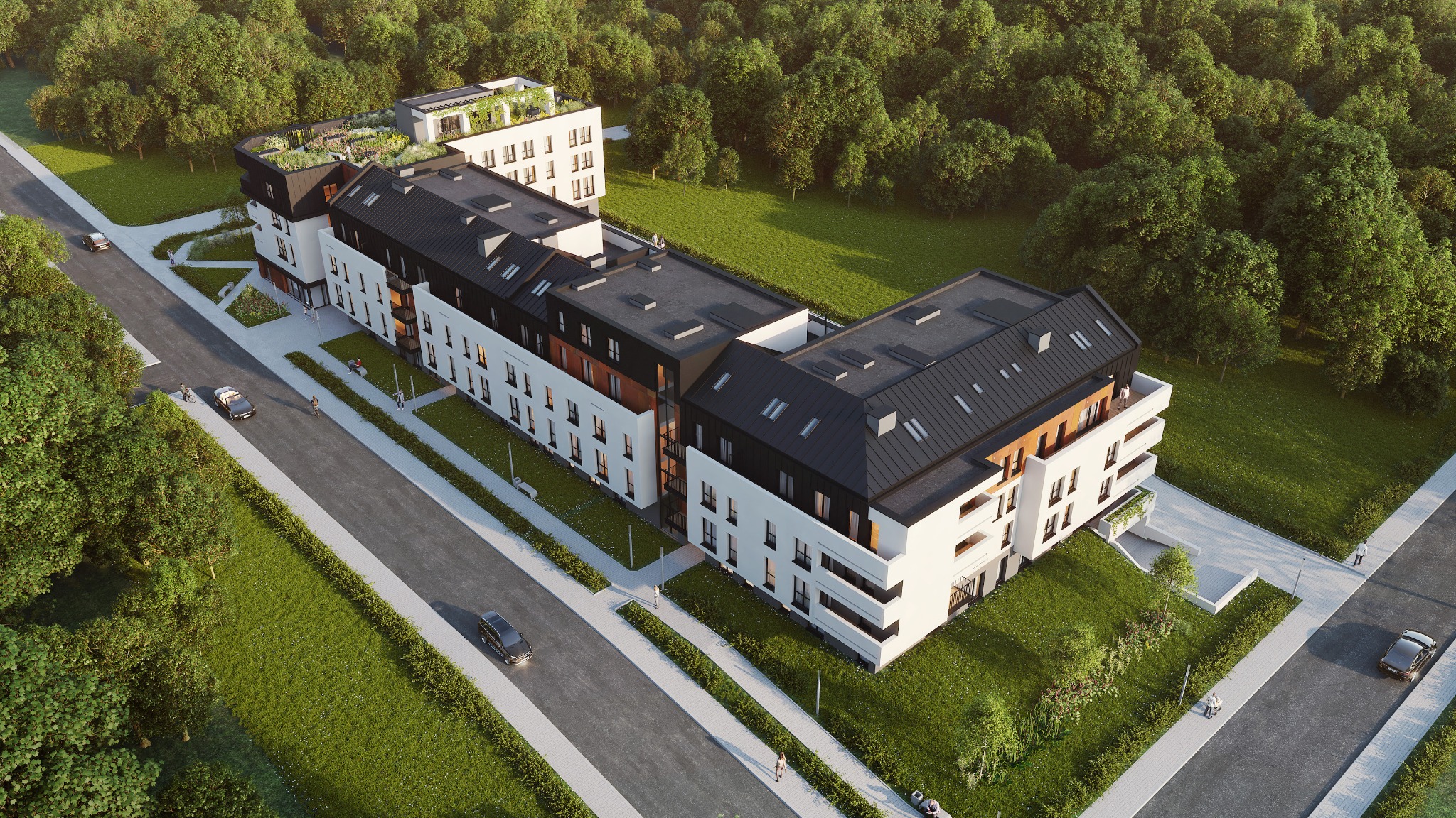 Wizualizacja z lotu ptaka nowoczesnego, wielorodzinnego budynku z białymi elewacjami, czarnymi dachami i zielonym dachem na najwyższej kondygnacji, otoczonego zielenią i drogami.