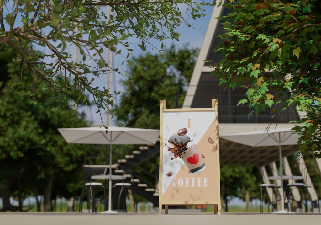 Drewniany stojak reklamowy z grafiką kawy z sercem, umieszczony przed nowoczesną kawiarnią z parasolami i stolikami na zewnątrz.