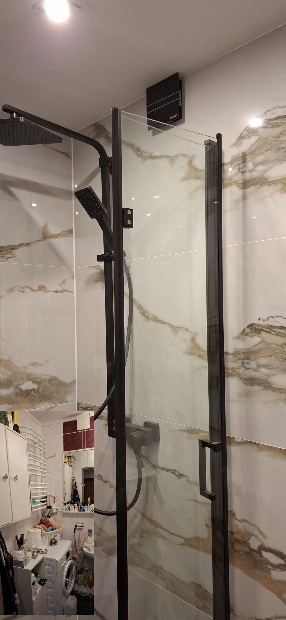 Kabina prysznicowa z czarnymi ramami i deszczownicą na tle marmurowych płytek, widoczny fragment łazienki z pralką i wyposażeniem.