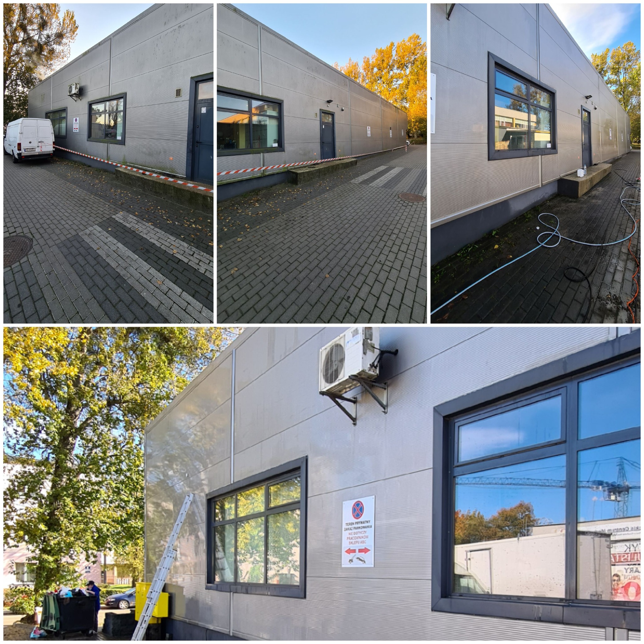 Szara hala przemysłowa z widocznymi śladami po umyciu elewacji, w tle drzewa z jesiennymi liśćmi, na chodniku leżące węże do mycia pod ciśnieniem.