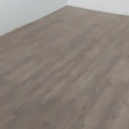 Ułożone panele podłogowe w odcieniach szarości, widoczna biała ściana i fragment białej obudowy pieca lub grzejnika, w rogu widoczne materiały budowlane.