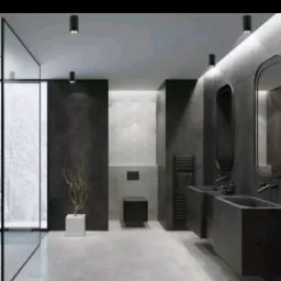 Nowoczesna łazienka w odcieniach szarości z heksagonalną podłogą, minimalistyczną armaturą i szklaną kabiną prysznicową, oświetlona punktowymi lampami sufitowymi.