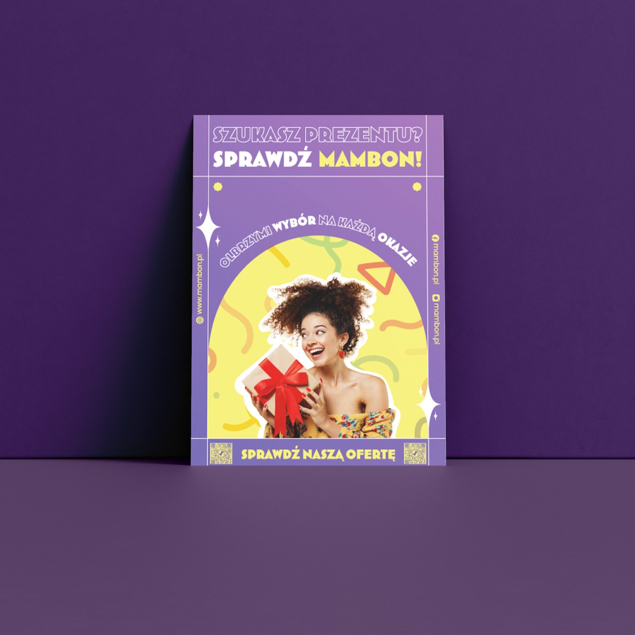 Ulotka reklamowa Mambon z uśmiechniętą kobietą trzymającą prezent, na fioletowym tle z linkami do strony internetowej i social mediów.