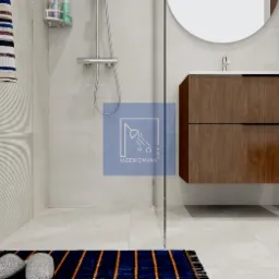 Nowoczesna łazienka z kabiną prysznicową, wiszącą szafką z umywalką i okrągłym lustrem, ręcznikiem w paski i dywanikiem z frędzlami.