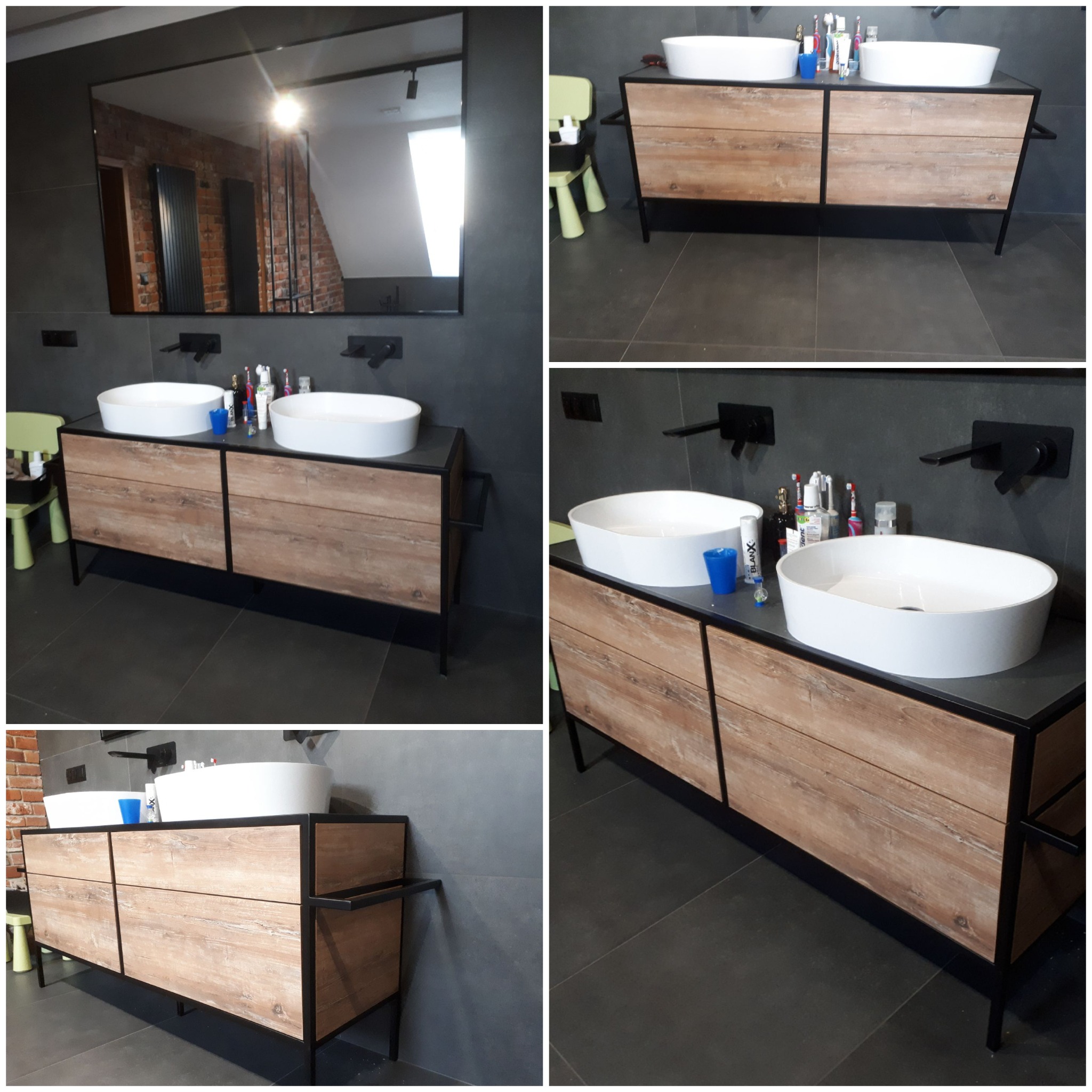 Nowoczesna łazienka z podwójną umywalką nablatową na drewnopodobnej szafce z czarnymi metalowymi nogami i armaturą, widoczne kosmetyki i akcesoria, w tle lustro odbijające ceglaną ścianę.