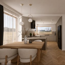 Avles Studio - Nowoczesna, otwarta przestrzeń kuchenno-jadalniana z drewnianym stołem i beżowymi krzesłami. W tle L-kształtna zabudowa z czarną lodówką, okapem i dużym oknem z widokiem na zieleń. Drewniana...