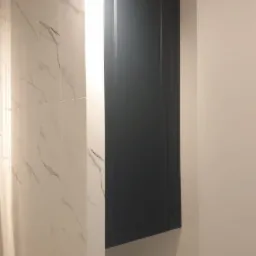 Wykonano szafkę wnękową w łazience, ponad pralką - front płyta lakierowana, frezowana mat.