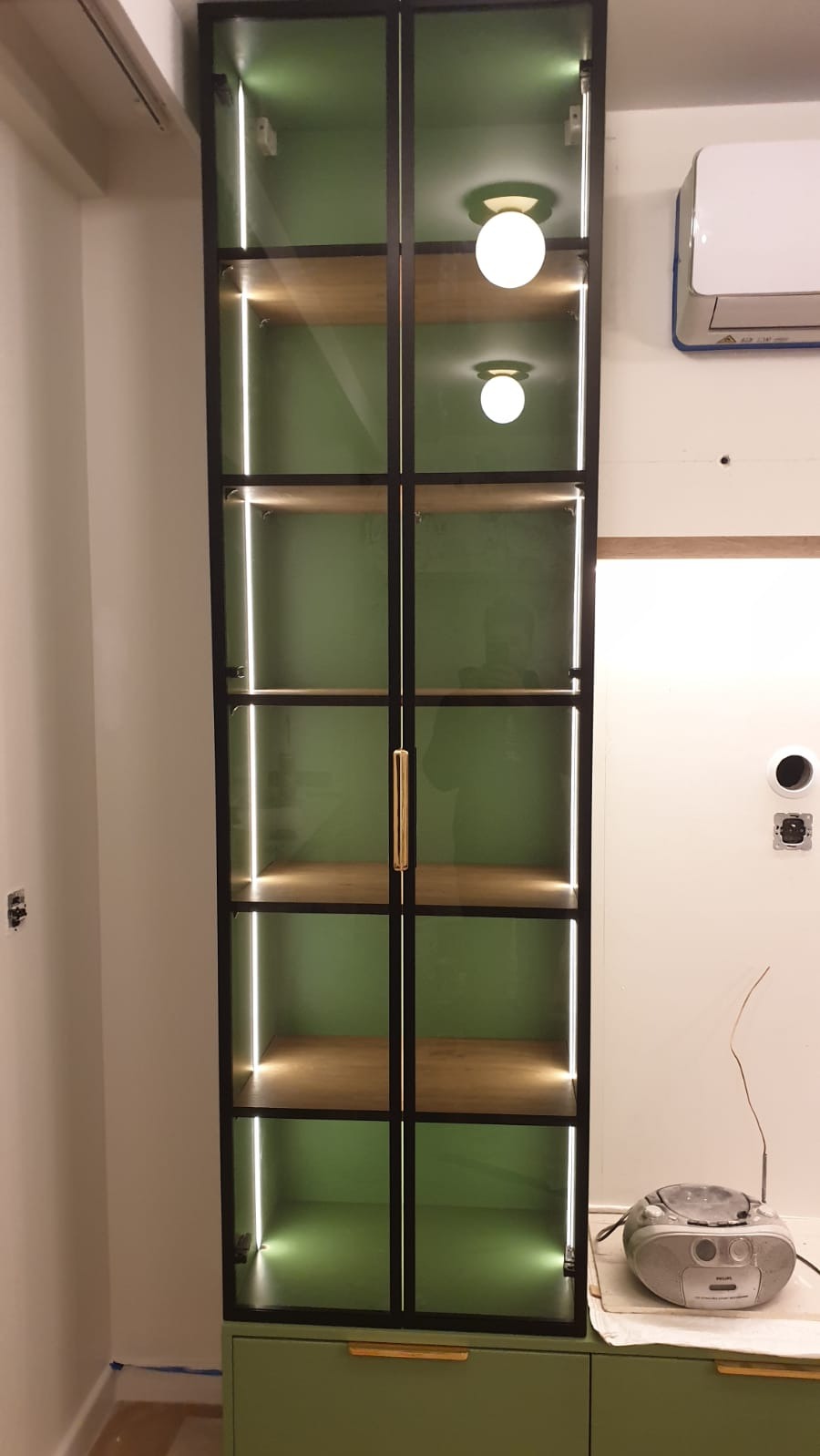 Wykonano witrynę z przeszklonymi frontami w ramce, korpusy płyta lakierowana mat, wewnątrz led