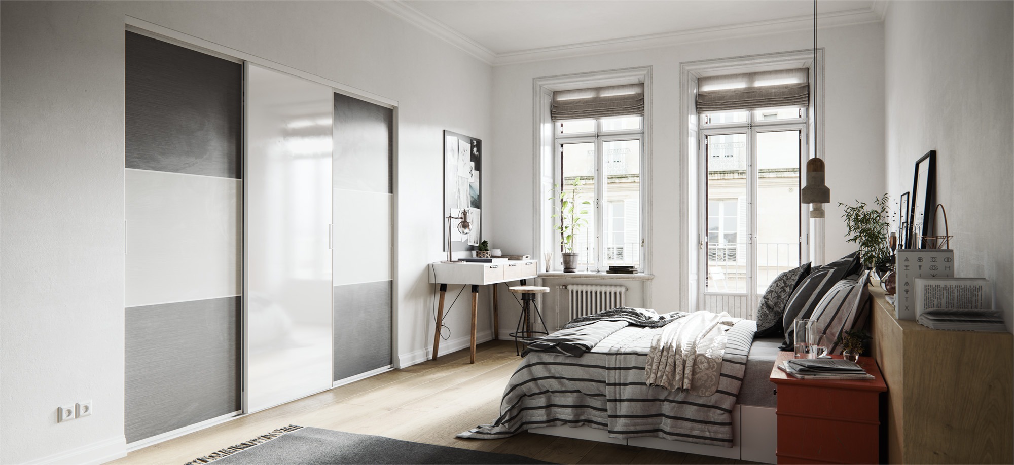 Jasne wnętrze sypialni z przesuwną szafą w odcieniach szarości i bieli, biurkiem przy oknie i łóżkiem w paski.