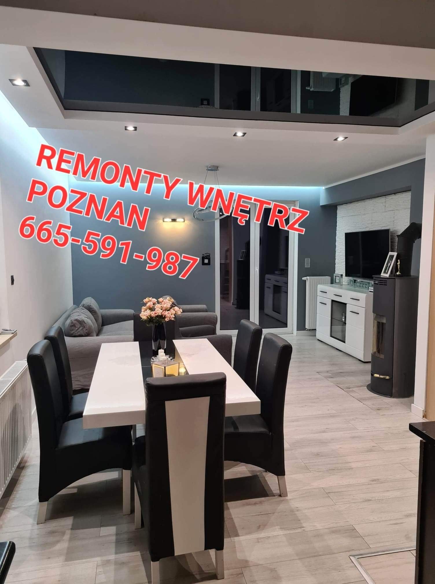 Nowoczesne wnętrze salonu z jadalnią, biało-szare ściany, biały stół z czarnymi krzesłami, szara sofa, kominek i sufit podwieszany z oświetleniem punktowym.