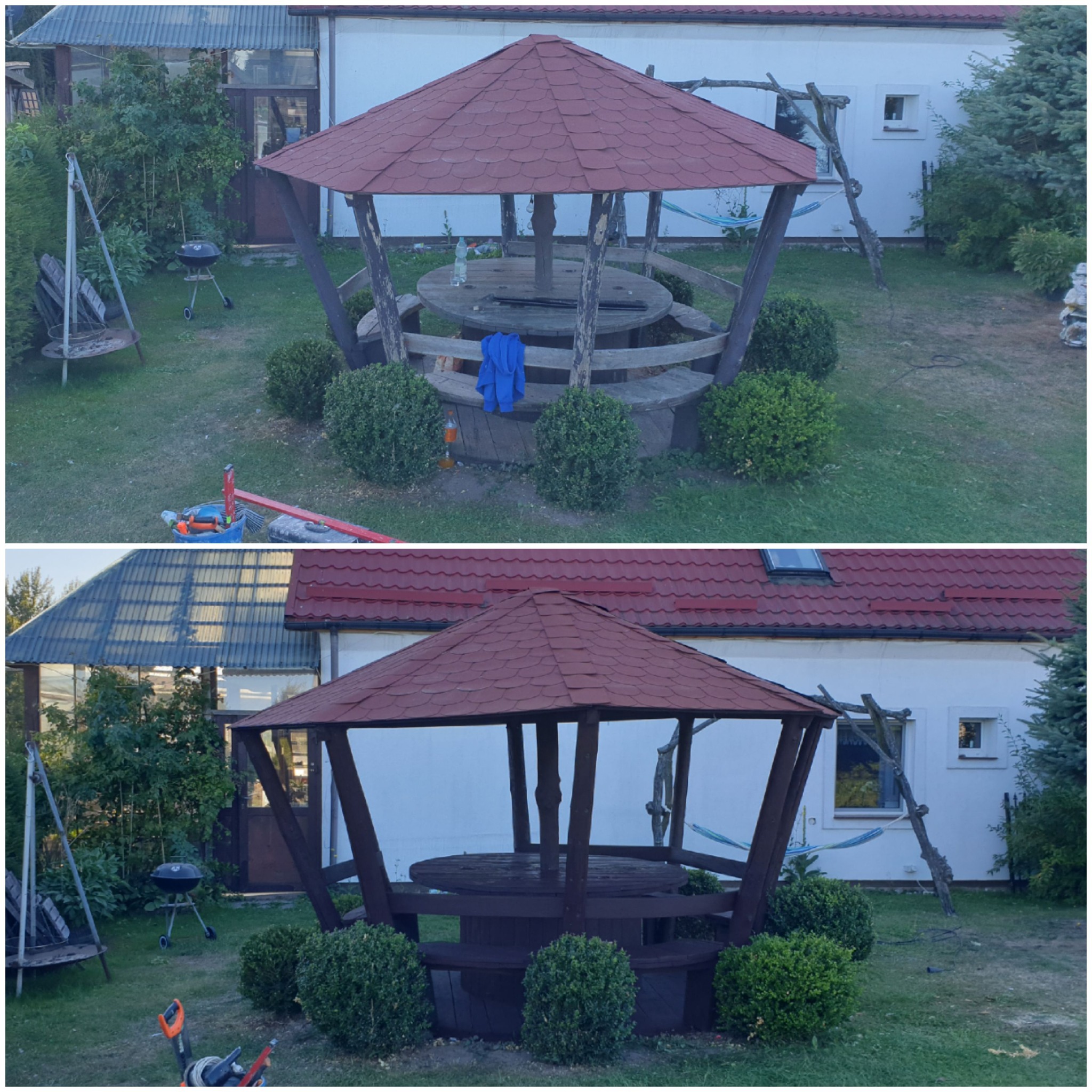 Drewniana altana ogrodowa z czerwonym dachem z gontów, okrągłym stołem i ławkami, otoczona bukszpanami, na trawniku przed białym budynkiem z widoczną huśtawką i grillem.