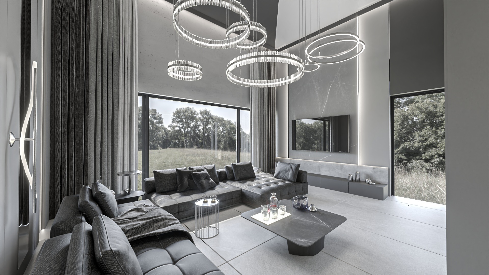 Nowoczesny salon w odcieniach szarości z dużym narożnikiem, okrągłymi lampami wiszącymi i widokiem na zieleń za oknem.